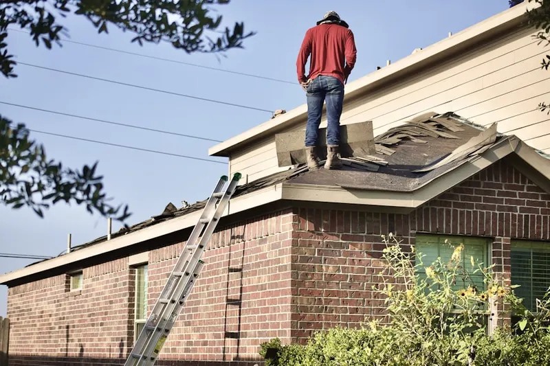 Professional roofer working on a residential roof in West Berlin
